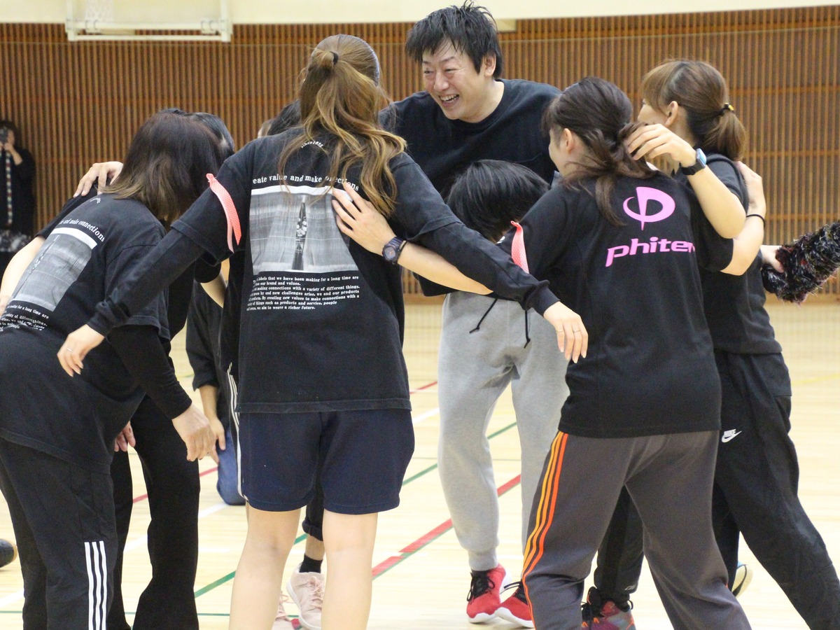 社内運動会でチームごとに円陣を組む社員